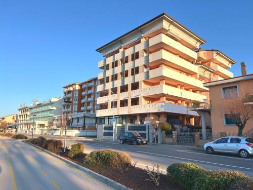 a building on the side of a street with cars parked at Capitol Apartments in Grado