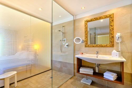 a bathroom with a sink and a shower with a mirror at Hotel Boffenigo - The Golden Hour in Costermano sul Garda