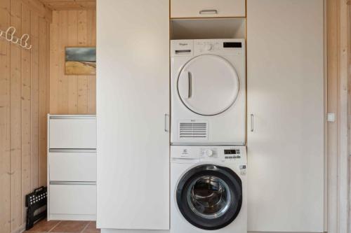 a laundry room with a washer and dryer at Cozy Summer House In North Jutland in Fjerritslev