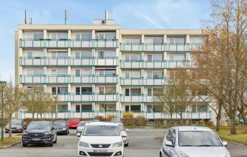 a parking lot with cars parked in front of a building at Stunning Apartment In Anklam in Anklam