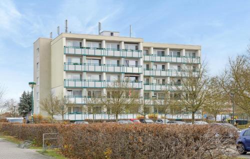a tall building with cars parked in front of it at Stunning Apartment In Anklam in Anklam
