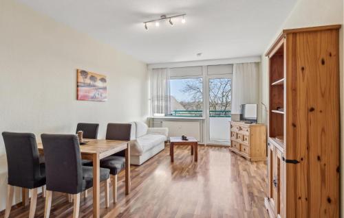 a living room with a table and chairs and a couch at 1 Bedroom Gorgeous Apartment In Anklam in Anklam