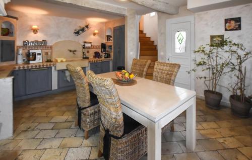 a kitchen with a white table and chairs at 2 Bedroom Lovely Home In Vedène in Vedène