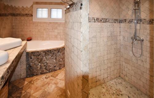 a bathroom with a shower and a tub and a sink at 2 Bedroom Lovely Home In Vedène in Vedène