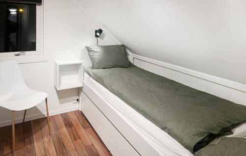 a bed in a small room with a window at Lovely Apartment In Vanse With Wifi in Vanse
