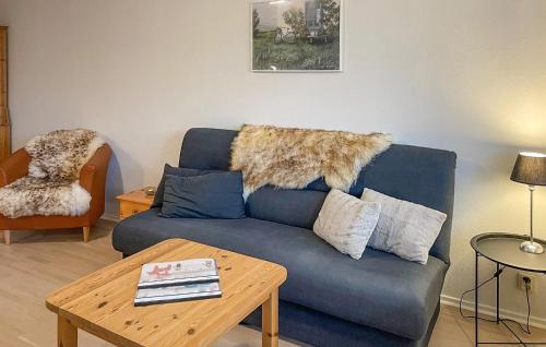 HyltebrukNice Apartment In Hyltebruk With Wifi的客厅里有一张蓝色的沙发和一张桌子