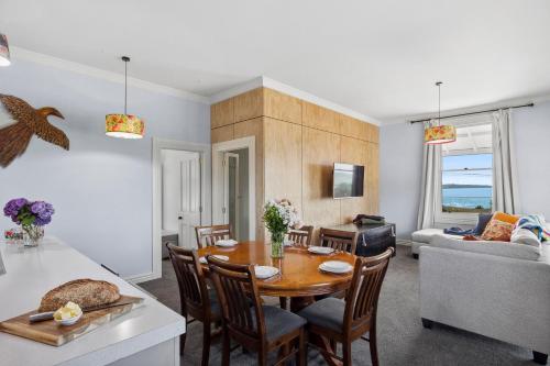 a kitchen and living room with a table and chairs at Moeraki Beach Haven - Otago Beachfront Home in Moeraki