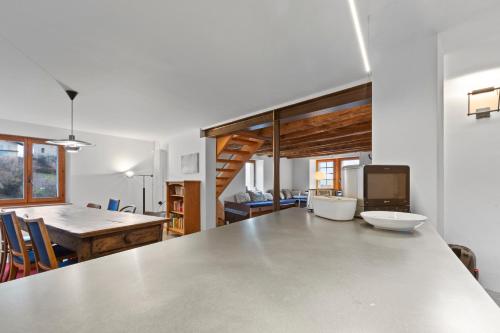 a kitchen and dining room with a large table at Maison 9 personnes a Venthône, sauna et vue in Venthone