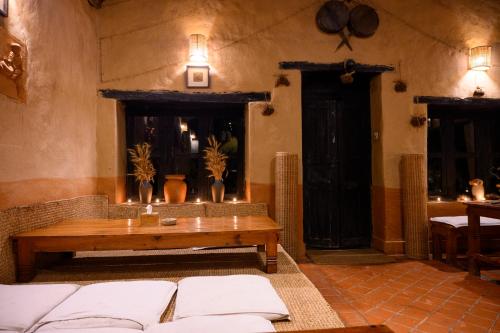 a living room with a couch and a table at Prakriti Resort and Organic Farm Pvt. Ltd. in Burhānilkantha