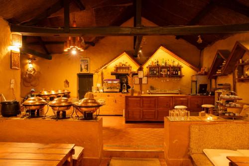 a large kitchen with a stove in a room at Prakriti Resort and Organic Farm Pvt. Ltd. in Burhānilkantha