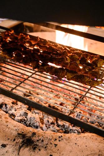 a rack of food cooking in an oven at Prakriti Resort and Organic Farm Pvt. Ltd. in Burhānilkantha