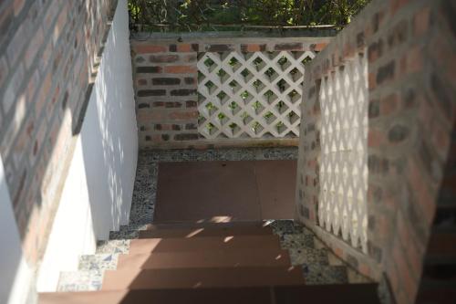 a brick wall with a white fence on it at mehome in Cư Chinh