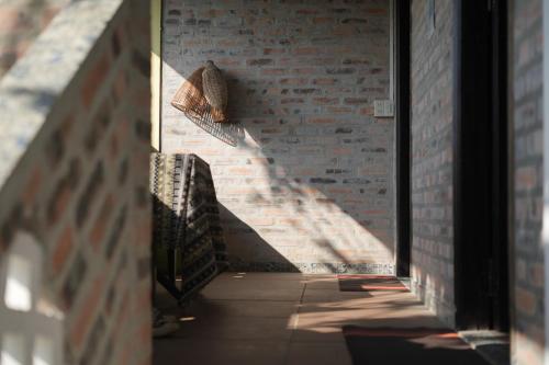 a hallway with a brick wall and a stair case at mehome in Cư Chinh