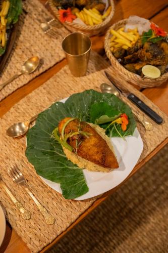 a plate of food with a sandwich on top at Prakriti Resort and Organic Farm Pvt. Ltd. in Burhānilkantha