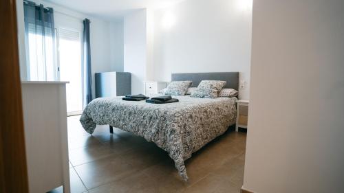 a bedroom with a bed with a patterned bedspread at Cuchillos de la fonseca in Casas de Moya