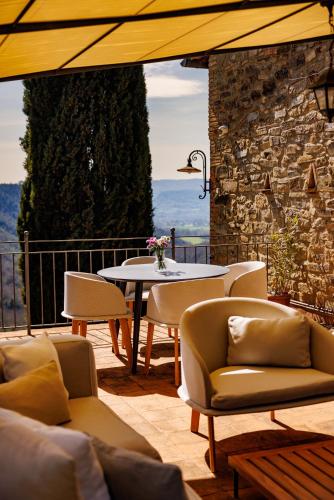 a patio with a table and chairs and a table and chairs at Antichi Casali di Charme in Orvieto