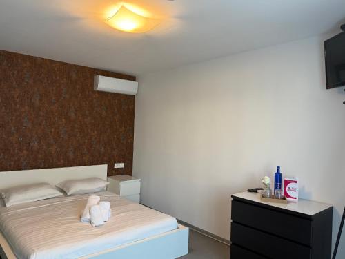 a bedroom with a bed with a stuffed animal on it at Rodizio Hill Resort in Cluj-Napoca