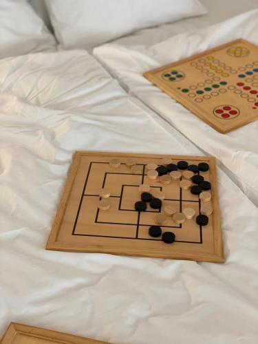 a wooden chess game on a bed at Apartment im Wein- und Freizeitidyll Klöch in Klöch