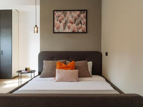 a bedroom with a large bed with orange pillows at Aura - Old Town I Free street parking I Self check-in in Bucharest
