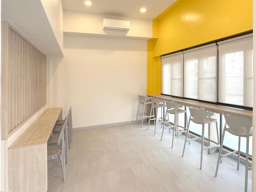 a dining room with chairs and tables and yellow walls at HOP INN Songkhla in Songkhla