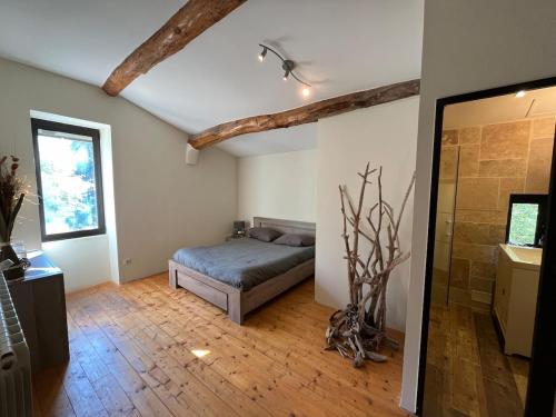 une chambre avec un lit dans le coin d'une pièce dans l'établissement MAS de PUJOL, à Saint-Pargoire