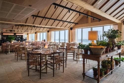 a dining room with tables and chairs and windows at Copenhagen Admiral Hotel in Copenhagen