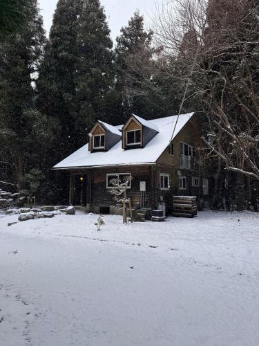a house with a snow covered roof in the snow at Rental villa Gontaya in Takamori