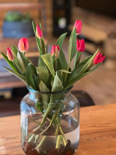 a vase filled with pink flowers sitting on a table at Rental villa Gontaya in Takamori