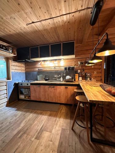 a kitchen with wooden cabinets and a wooden table at Rental villa Gontaya in Takamori