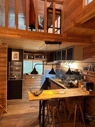 a kitchen with wooden walls and a wooden table at Rental villa Gontaya in Takamori
