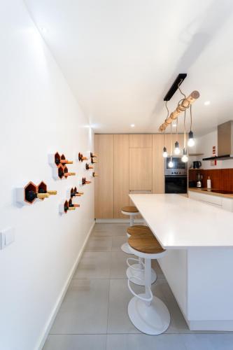 a kitchen with a white counter and wooden cabinets at Casa de Maiorca in Maiorca