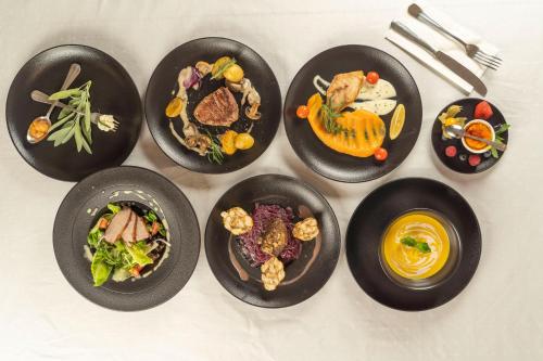 a group of plates of food on a table at Hotel Kolonie in Frýdlant nad Ostravicí