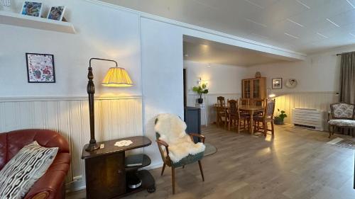 a living room with a couch and a table and chairs at Nonstinden View Lofoten in Ballstad