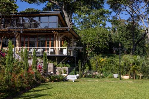 a house with a porch and a lawn at Pax Manor Muthaiga in Nairobi