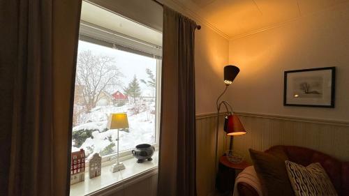 a room with a window with a view of snow at Nonstinden View Lofoten in Ballstad