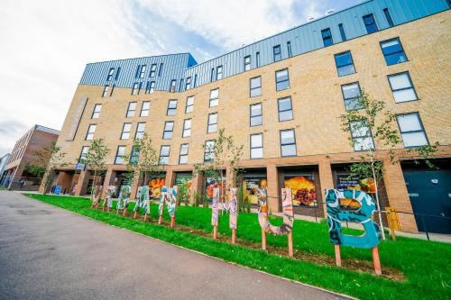 a building with a row of signs in front of it at URBAN HUB Student Accommodation in Preston