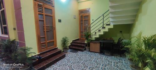 a building with stairs and plants in a hallway at Shree dham home stay in Faizābād