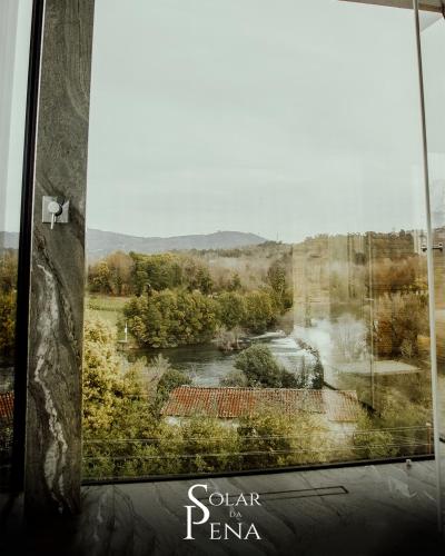 a view of a river from a window at Quinta das Areias - Solar da Pena in Braga