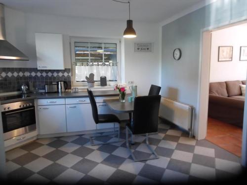 a kitchen with a table and chairs and a couch at Ferienhaus Mit Garten Und Stellplatz in Großenaspe
