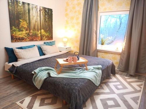 a bedroom with a bed with a table on it at Serene Holiday Home next to Nature Reserve in Kärde