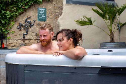 a man and a woman in a bathtub at Ferienhaus Maifelder Wellness Loft In Gappenach in Gappenach
