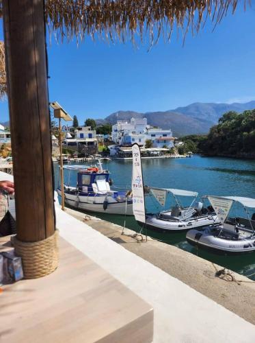 two boats are docked in the water at a marina at Harbour lights by Smaris Collection in Sissi