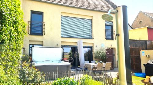 a house with a bath tub in the yard at Ferienhaus Maifelder Wellness Loft In Gappenach in Gappenach