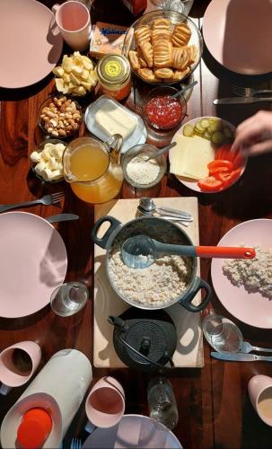 a table full of food with a pot of food at Serene Holiday Home next to Nature Reserve in Kärde