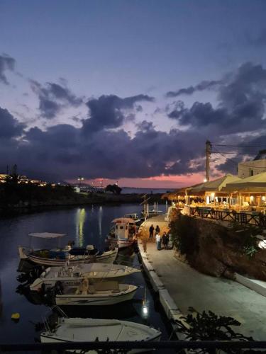 a group of boats docked at a marina at night at Harbour lights by Smaris Collection in Sissi