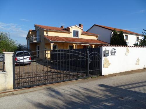a fence in front of a house at Villa Ana in Kaštel