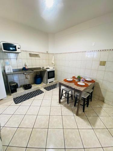 a kitchen with a wooden table in a room at Bela vista a beira mar in Marataizes