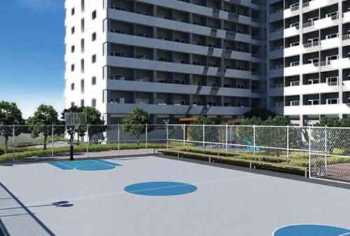 an empty basketball court in front of a building at Luxury for Less next to BGC and Makati CBD in Manila