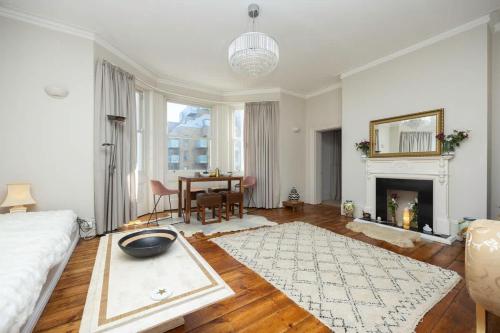 a large living room with a bed and a table at Host & Stay - St Aubyns Coastal Retreat in Brighton & Hove