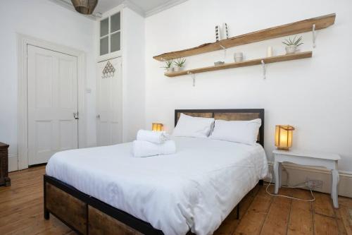 a bedroom with a large white bed and a desk at Host & Stay - St Aubyns Coastal Retreat in Brighton & Hove